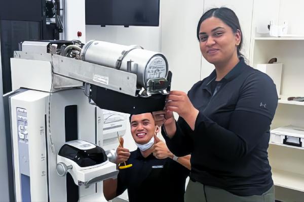 Technicians working with medical equipment in a lab setting.