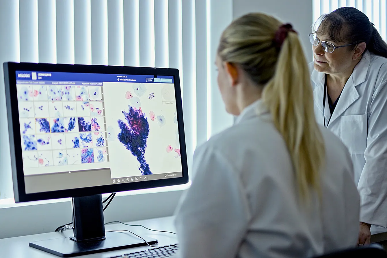Healthcare providers looking at monitor showing digital scans