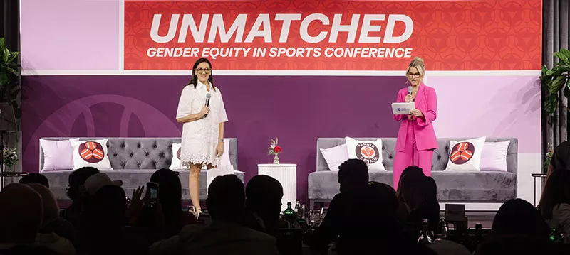 Speakers on stage talking to an audience.